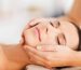 spa, resort, beauty and people concept - beautiful woman in spa salon getting face treatment